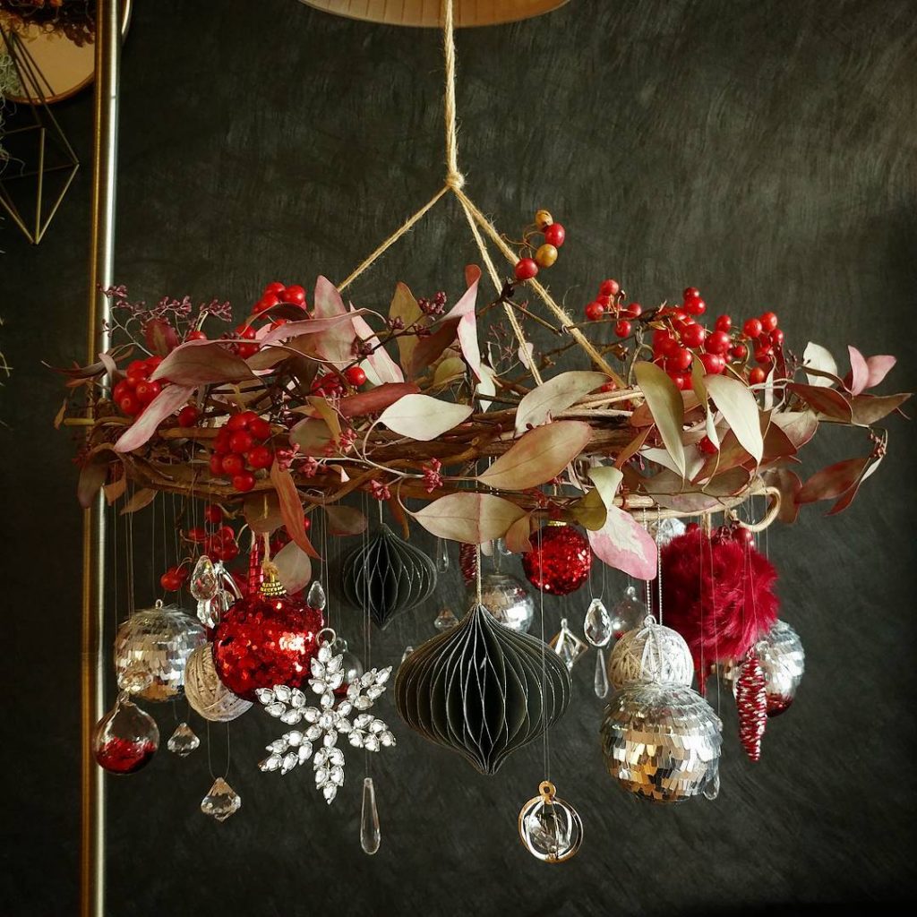 christmas wreath hanging from chandelier
