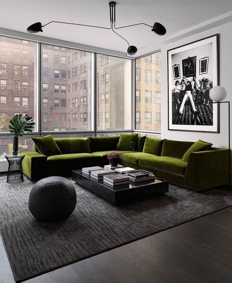 living room with green velvet sofa